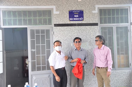 A group of people standing in front of a buildingDescription automatically generated